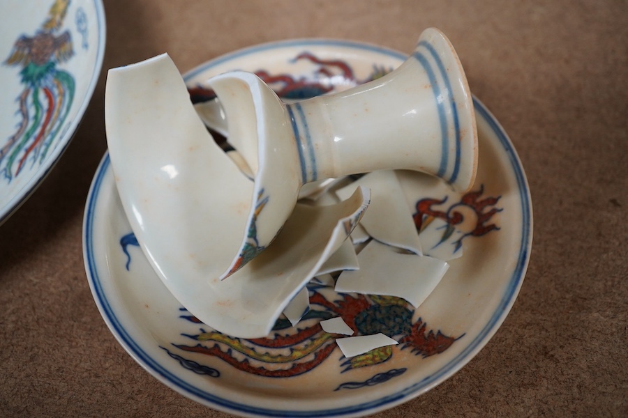 A pair of Chinese pedestal cups and three saucers. Condition - one cup severely damaged